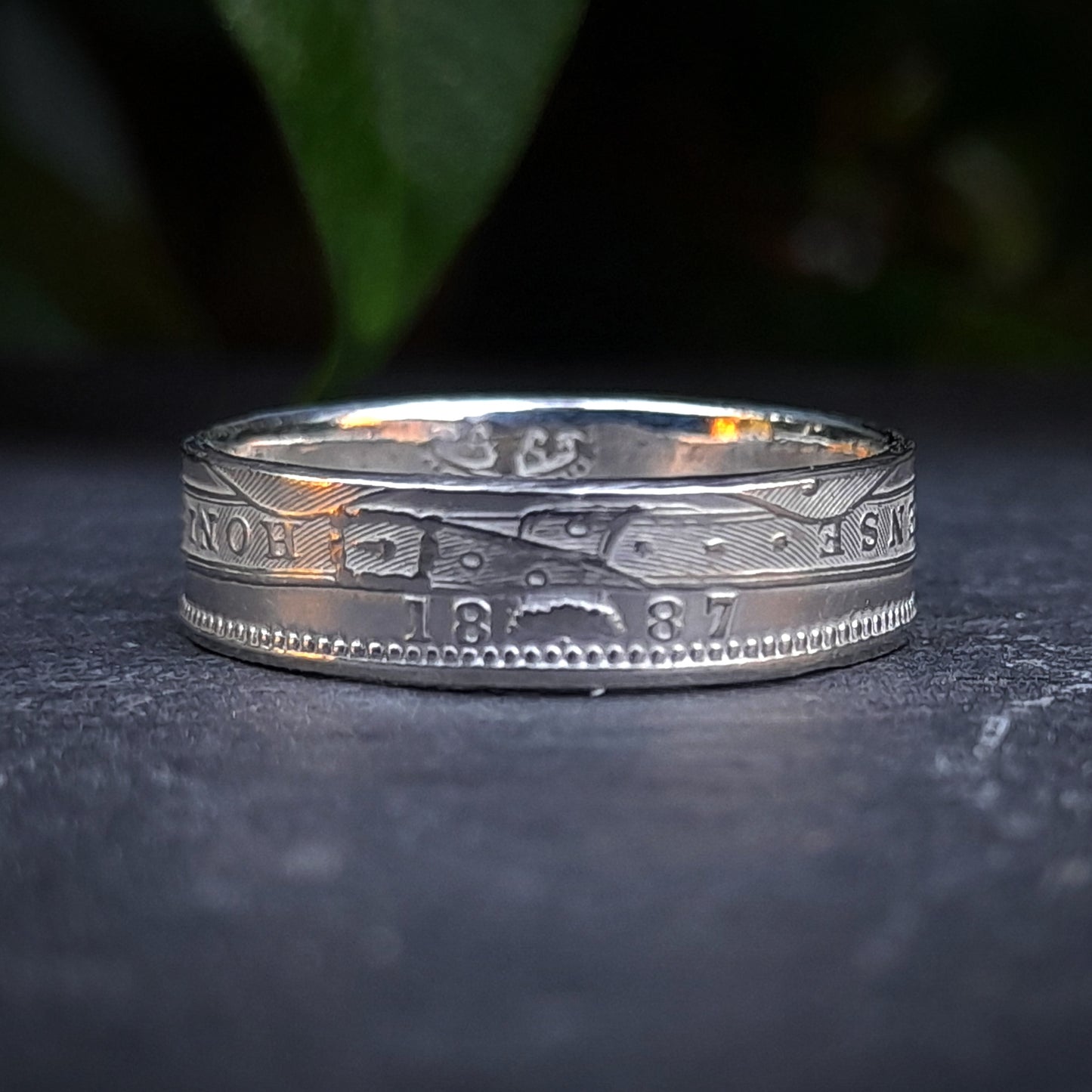 Handcrafted by silverhollowjewellery, the 1800s Victorian Shilling Ring is made from a genuine sterling silver coin, showcasing intricate engravings and the year 1887 on its surface.