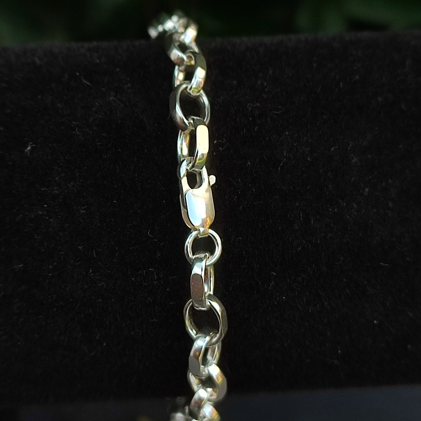 Close-up of the silverhollowjewellery Belcher Chain Bracelet—Sterling Silver, featuring diamond cut interlocking oval links, shown on a black velvet background.