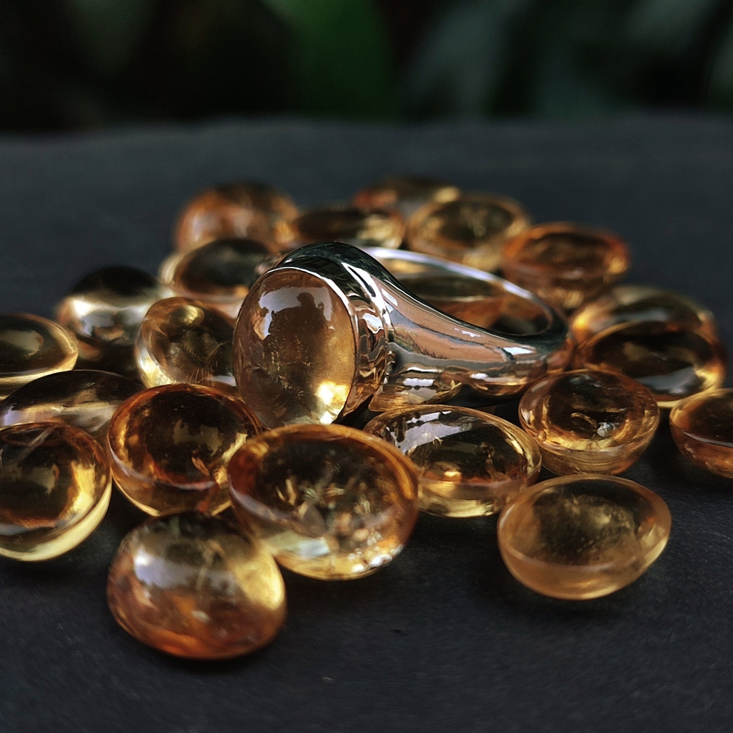 The Gold Bezel Citrine Ring by silverhollowjewellery features a stunning citrine gemstone set in gold, displayed on a dark surface to highlight its elegant, handcrafted design.