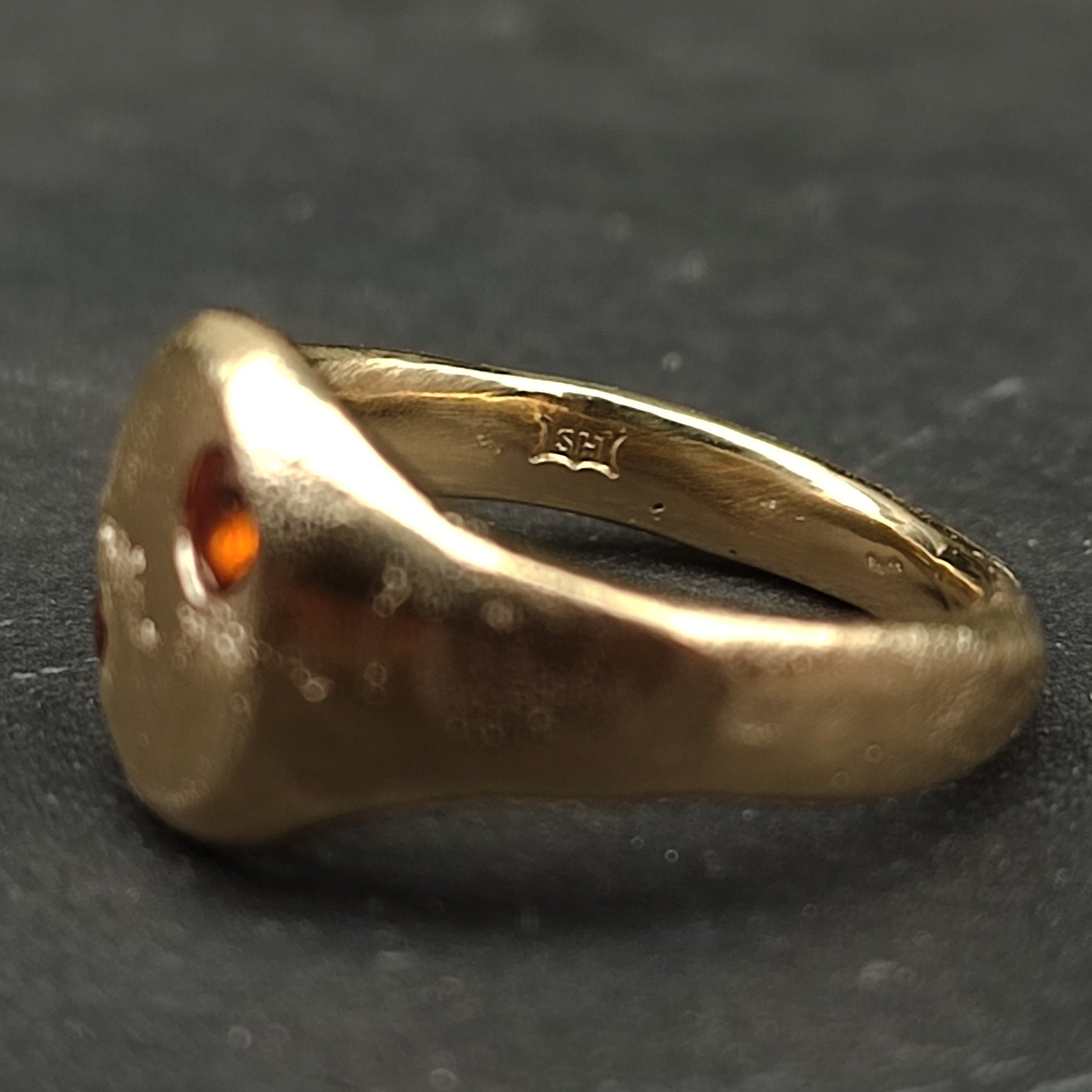 The 9ct Sandcast Sapphire Signet by silverhollowjewellery is a gold ring with a sapphire, shown from the side, featuring an inner band hallmark and crafted using traditional sand casting.