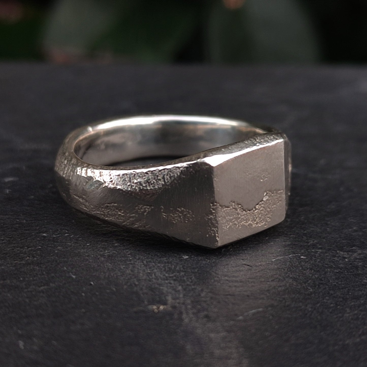 The Raw Square Signet by silverhollowjewellery is crafted from recycled 925 sterling silver, featuring a naturally textured, flat square face and shown on a dark background.