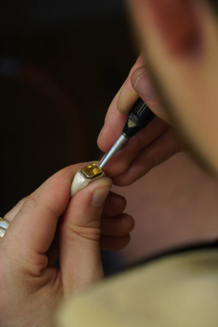 Dan repairing a sterling silver ring with gemstone set