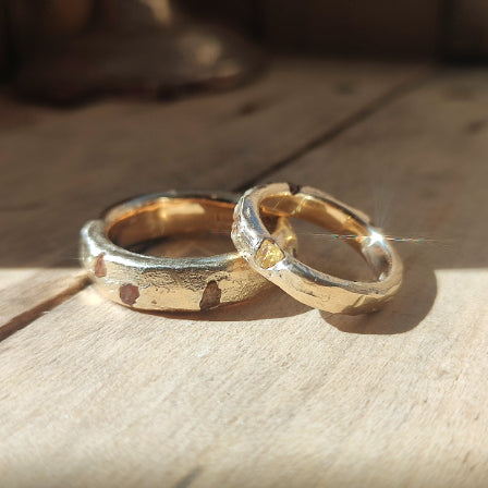 Gold sandcast nature inspired engagement rings displayed on a work bench