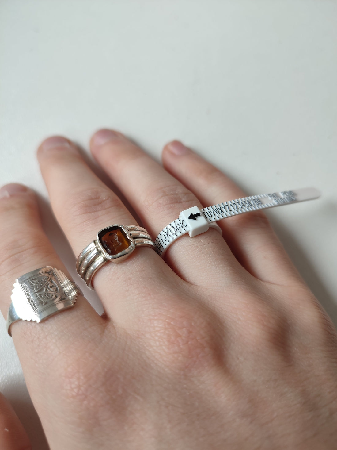 Adjustable ring sizer on finger