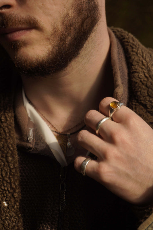man wearing alternative handmade jewellery in the woods