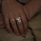 Close-up of hands with rings on a beige fabric background