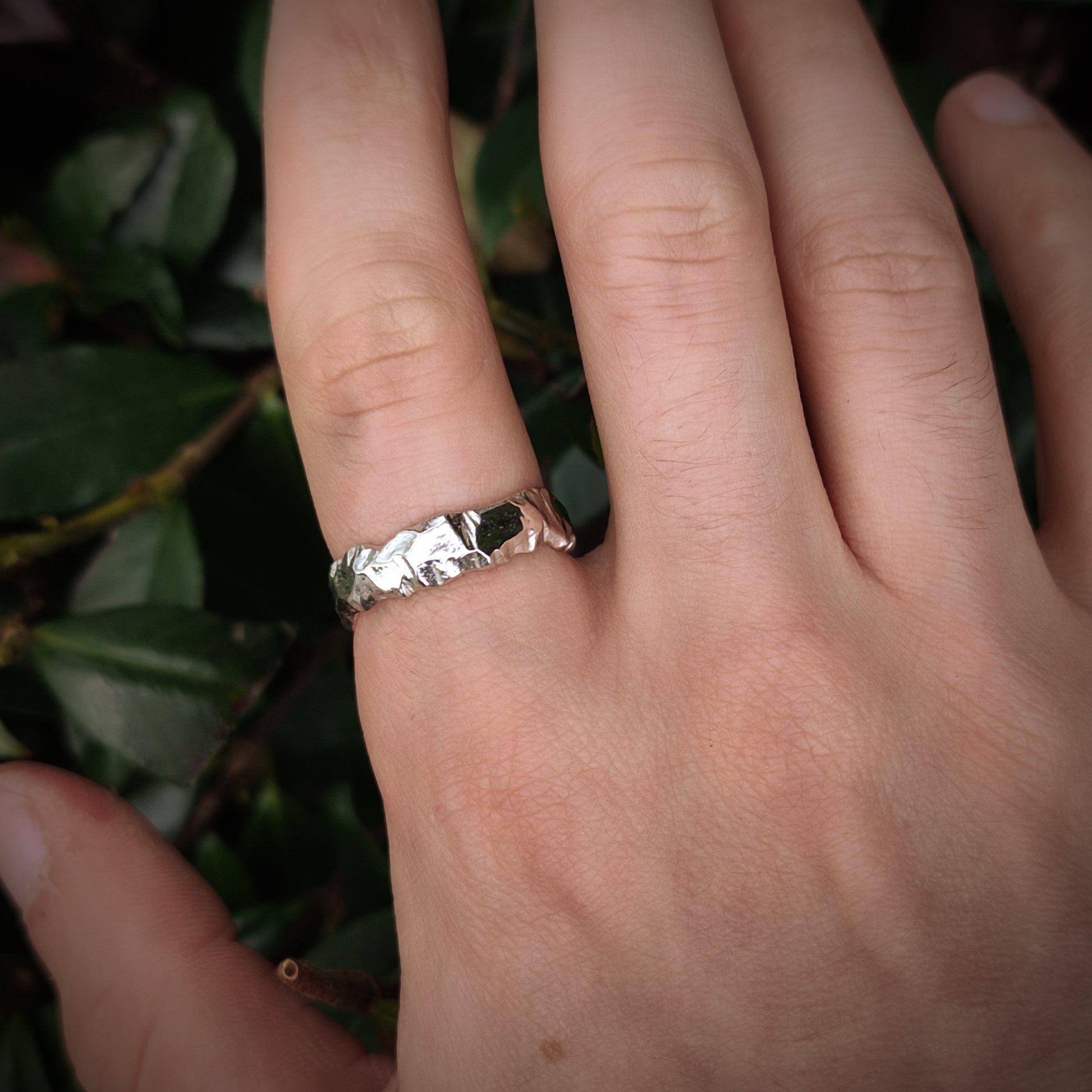 silver rock texture ring on hand