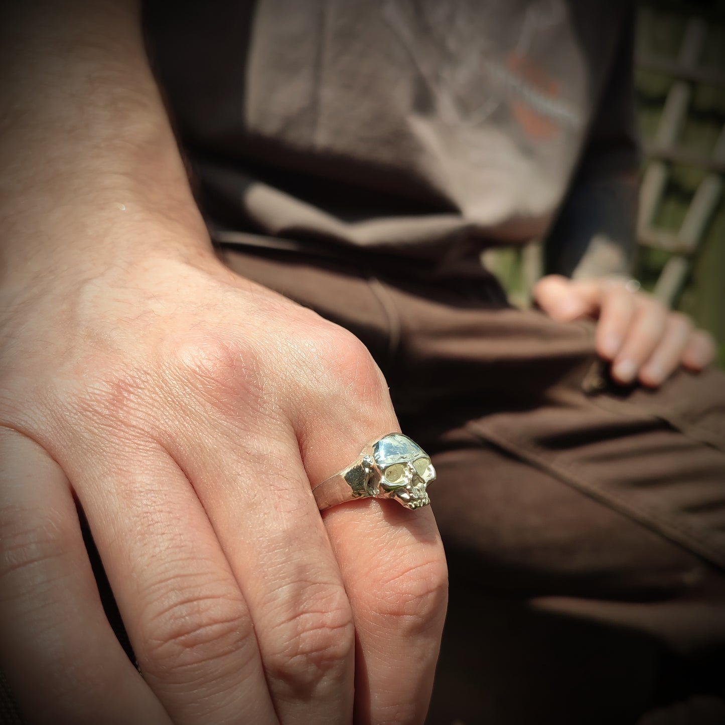 silver skull ring on hand